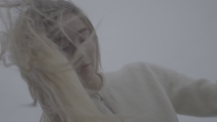 Woman with windswept blonde hair