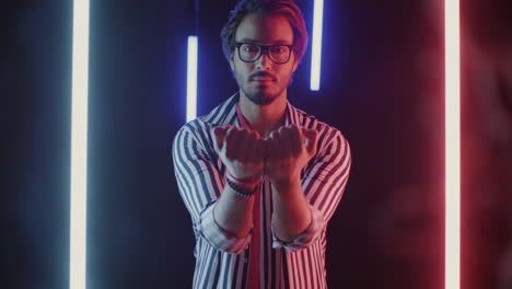 stylish man in striped shirt under neon lights