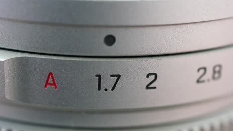 a silver lens that turns a aperture