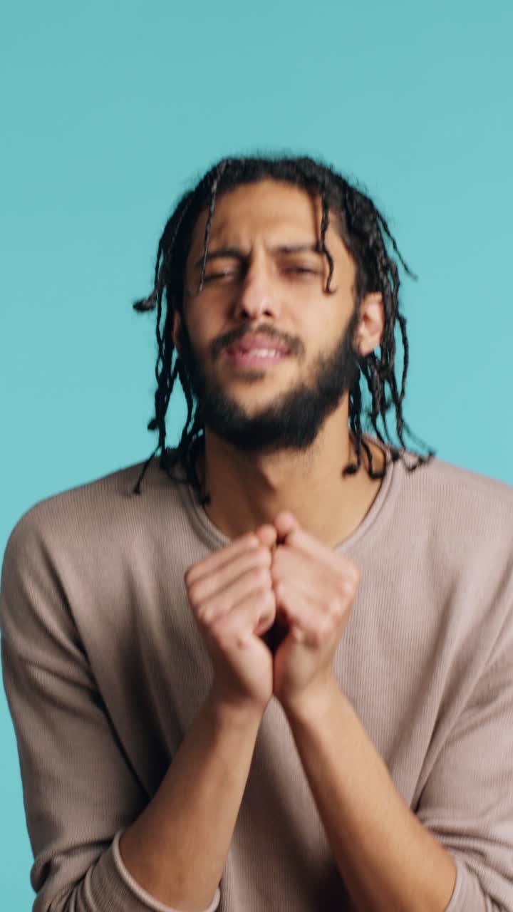 Vertical video Desperate guy asking for forgiveness, doing hands imploring sorry gesturing