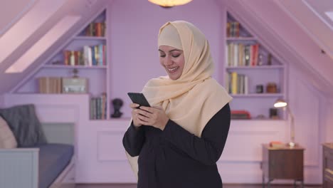 happy muslim woman chatting on phone