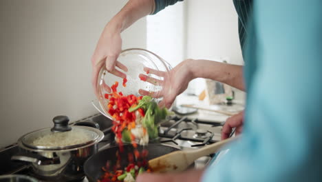 people cooking stir fry with vegetables