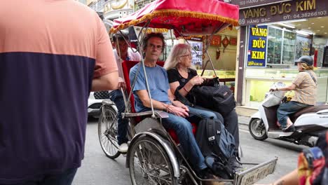 tourists enjoy cyclo ride through hanoi streets