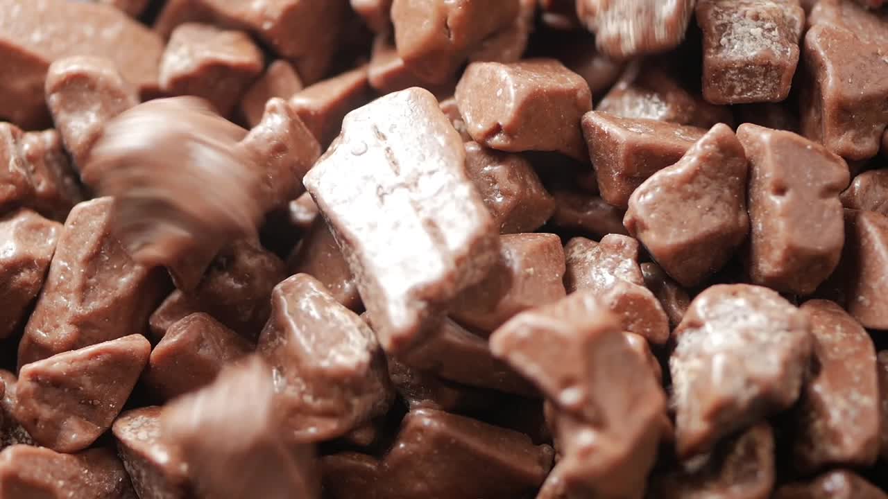 Close-up of Chocolate Pieces Falling into a Pile