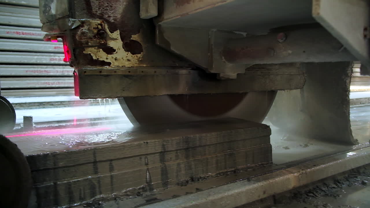 Huge round electric saw cutting the ferroconcrete plate easily. Equipment at modern construction plant. Close up.