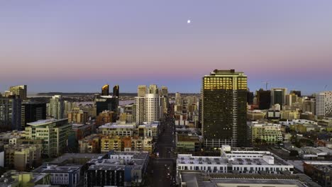 Aerial-view-over-streets-of-downtown-San-Diego,-dusk-in-California,-USA---reverse,-drone-shot