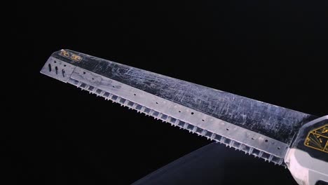 close-up of a dirty electric reciprocating saw blade