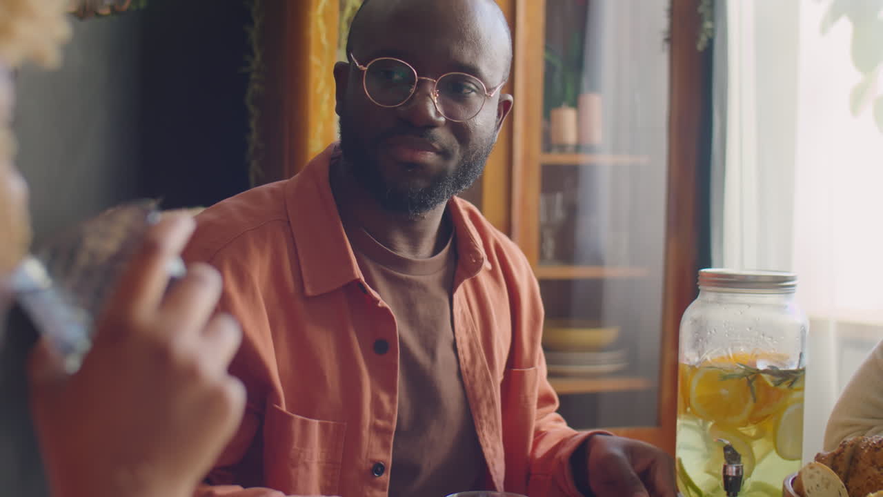 African American Man and Woman Talking at Home Dinner Party