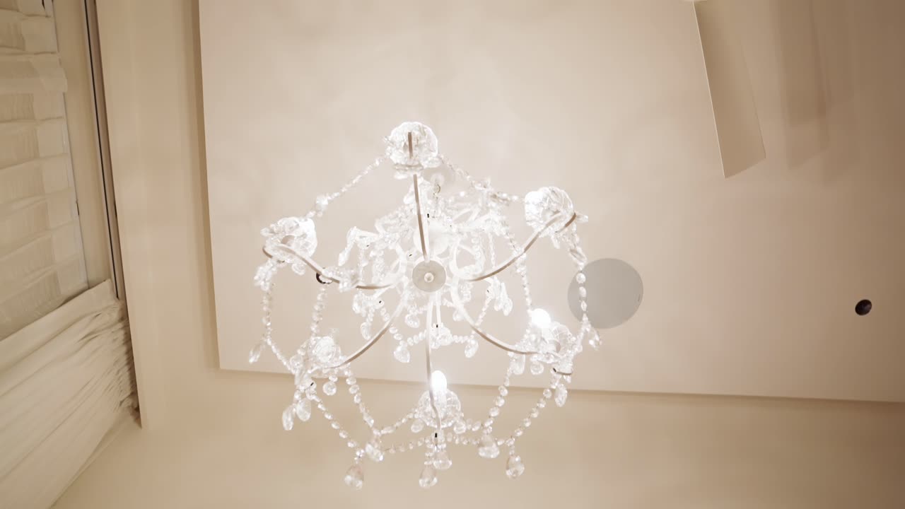 Luxurious Bedroom Decor with Chandelier and Pink Drapes