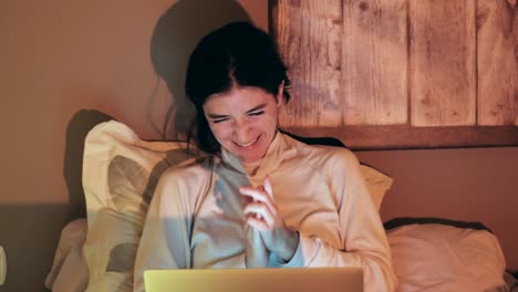 young woman enjoying content on laptop