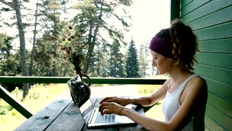 business woman tourist freelancer typing on a laptop in the summer outdoors at the recreation center