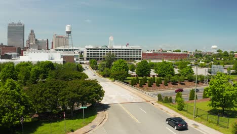 A-rising-drone-shot-of-the-Winston-Salem-skyline-in-North-Carolina-in-the-summer-over-the-freeway