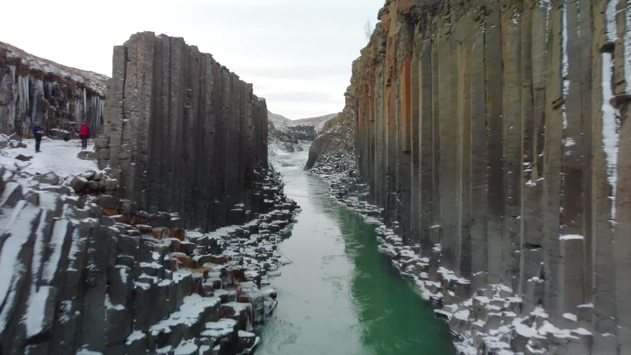 Flying through the Studlagil Canyon with the Jokulsa A Bru river in east Iceland, Europe. 4K UHD video