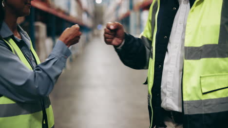 warehouse workers greeting each other