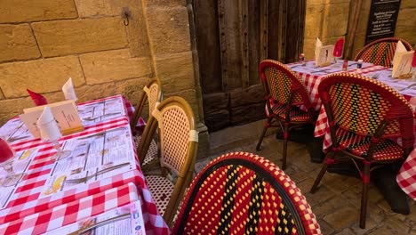 outdoor dining setup with red checkered tablecloths