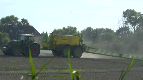 farmer spraying crops with tractor and sprayer