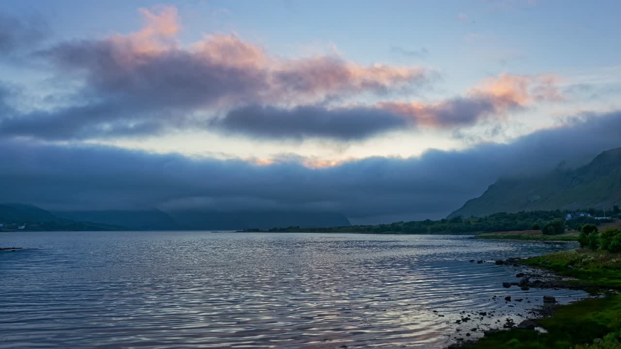 Mountains, lake in beautiful, pristine surroundings, and clouds and sea fog. Lofoten Islands, Northern Norway