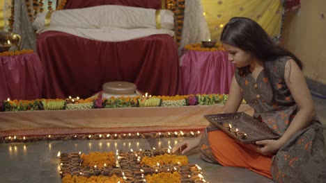 indian girl lighting diyas