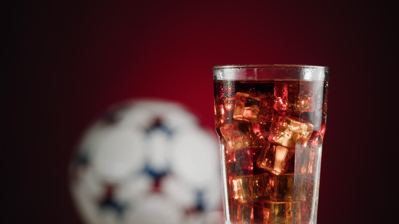 Iced Soda with Soccer Ball Background