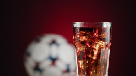 Iced Soda with Soccer Ball Background