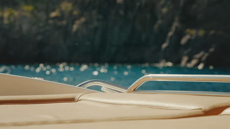 leather lounge bed on luxury yacht with shiny railing bobbing on water