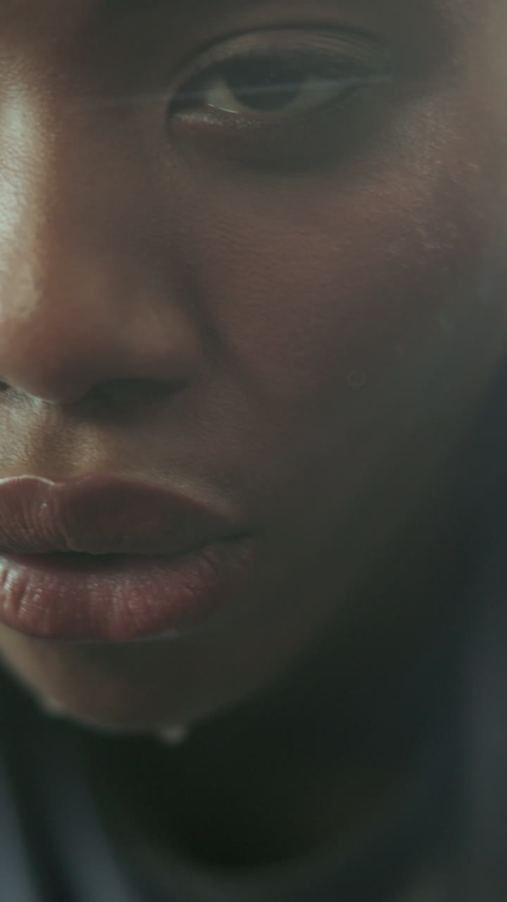 Dramatic Close-up of a Woman's Face with Water Droplets