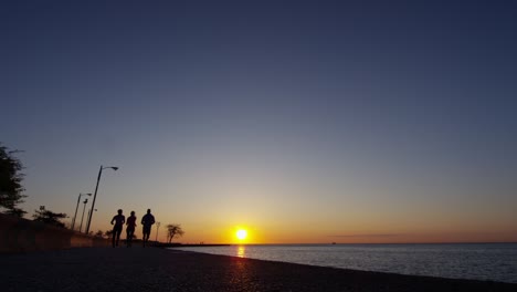 sunrise silhouette multi ethnic friends running in chicago