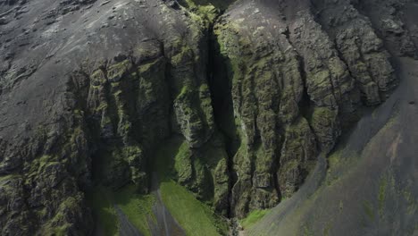 narrow crack between tall cliffs at popular ravine raudfeldsgja in iceland