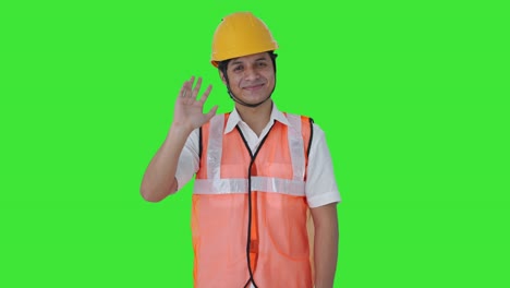 Happy-Indian-architect-waving-hello-Green-screen
