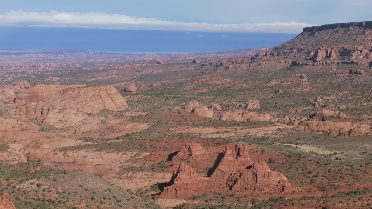 Scenic view of red rock formations under a vast sky in Moab, Utah