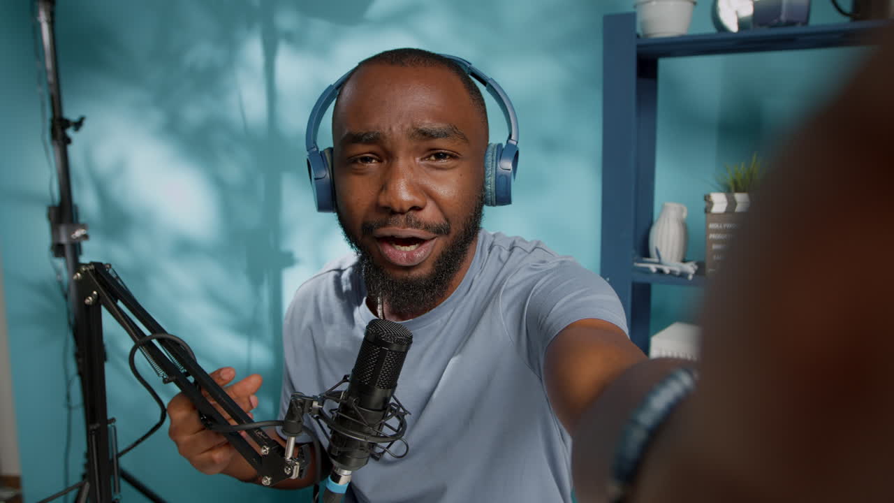 POV of influencer vlogging in studio and talking with microphone