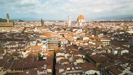 cloud shadows hide sunlight on top of brown buildings in florence italy