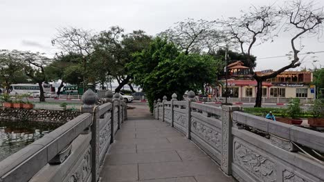 traditional bridge over water with temple view