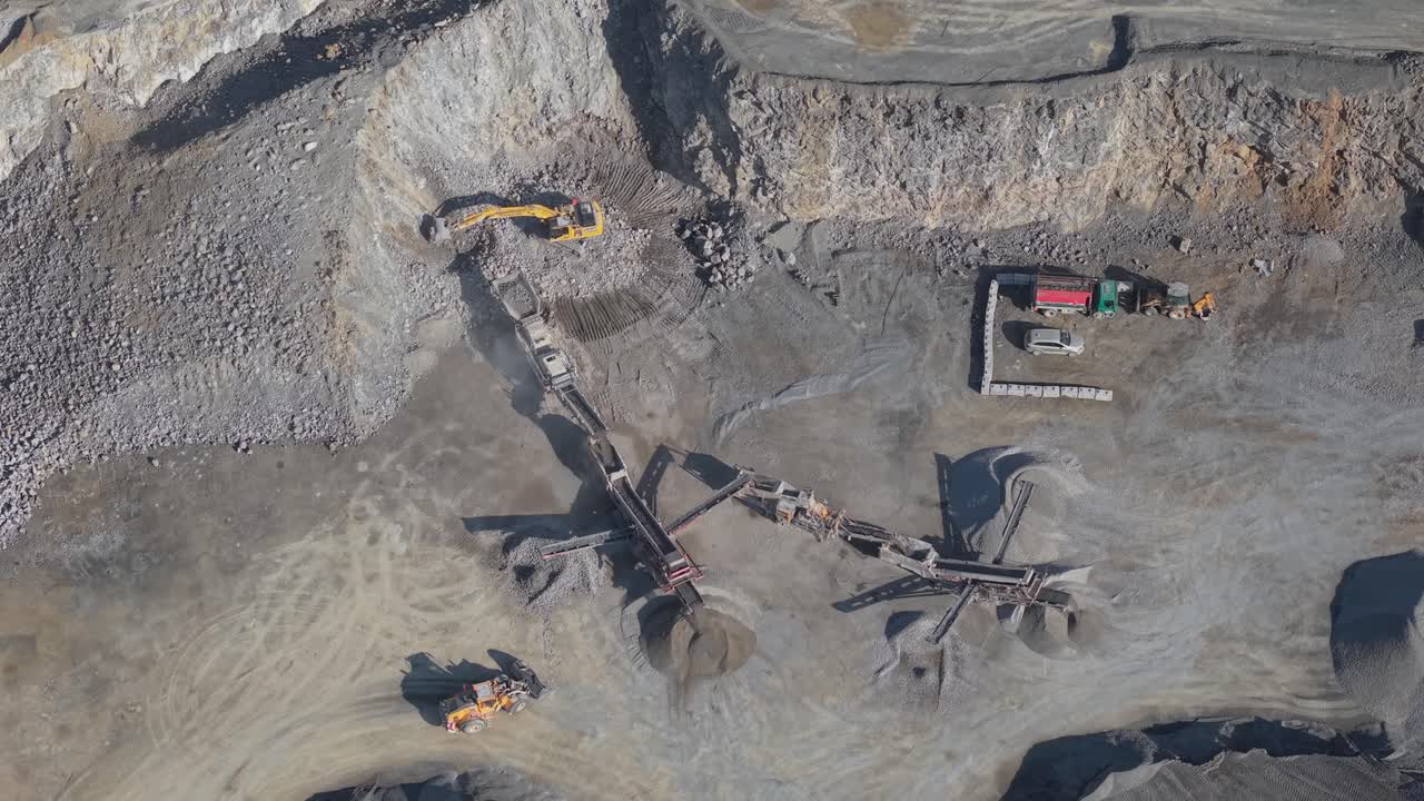 Quarry With Excavators, Conveyor Belts, And Trucks Processing And Transporting Aggregates In County Meath, Ireland. aerial topdown shot