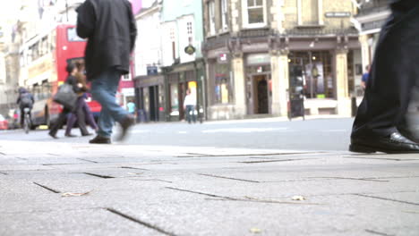 close up of pedestrian's feet walking on busy street