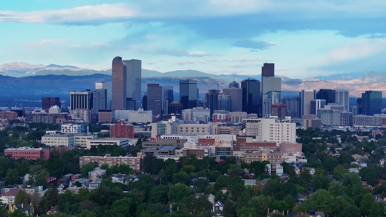 Klar luftoptagelse af downtown Denver med bjerge i horisonten, medium teleobjektiv drone-tilbagetrækning fra luften