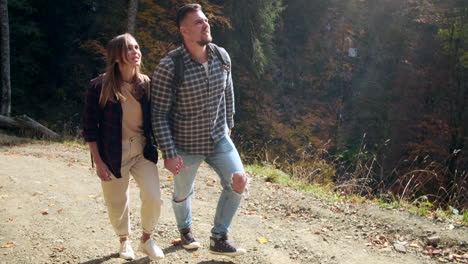 couple hiking in autumn forest