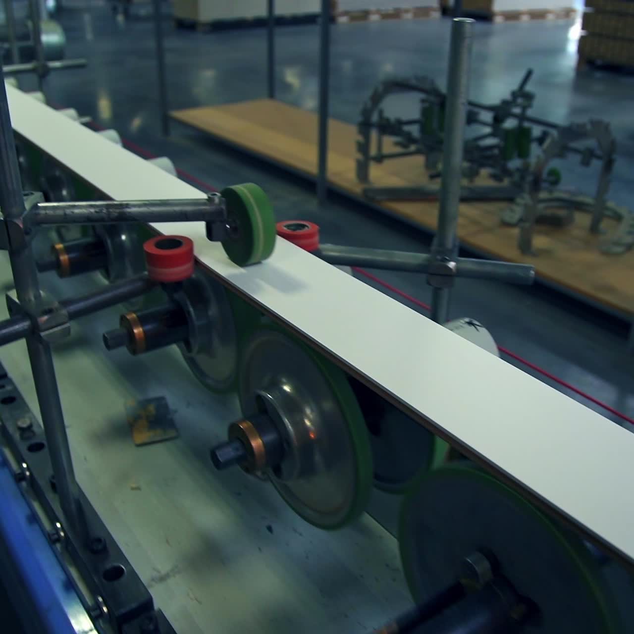 Modern equipment at factory manufacturing doors. Walking along the conveyor belt with numerous rollers rotating