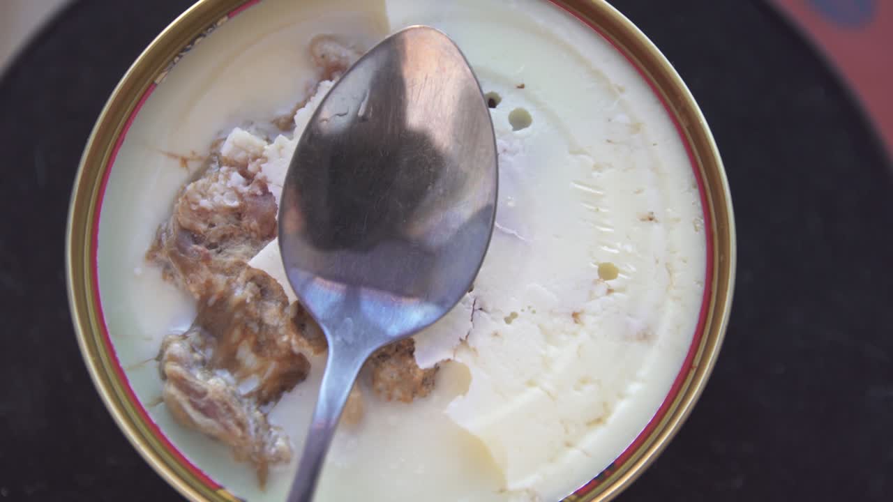 stew meat pork beef canned with a spoon, rotates