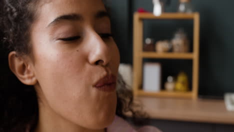 close-up of a person enjoying a slice of cheesy pizza