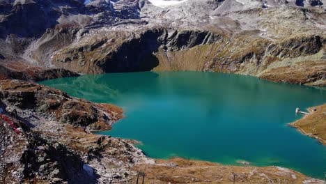 clear blue water of weisssee glacier lake surrounded with rocky peaks in austria