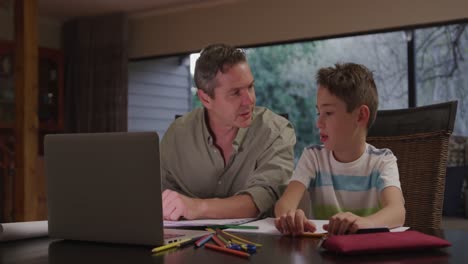 Caucasian-man-and-his-young-son-using-a-laptop