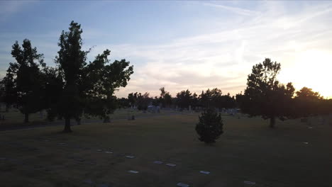 backward dolly above a cemetery in georgia during sunset