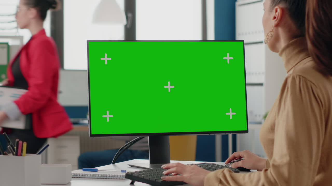Adult using green screen on computer display