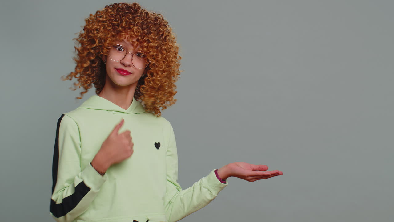 Girl child pointing empty place advertising area for commercial text copy space for goods promotion