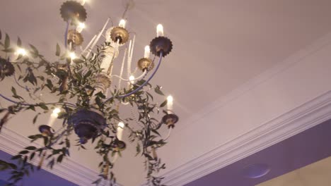 beautiful simple bright candlelight chandelier hanging from the ceiling -close up