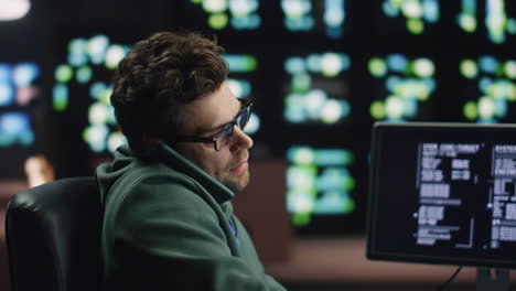 busy programer calling smartphone at night datacenter closeup. man talking
