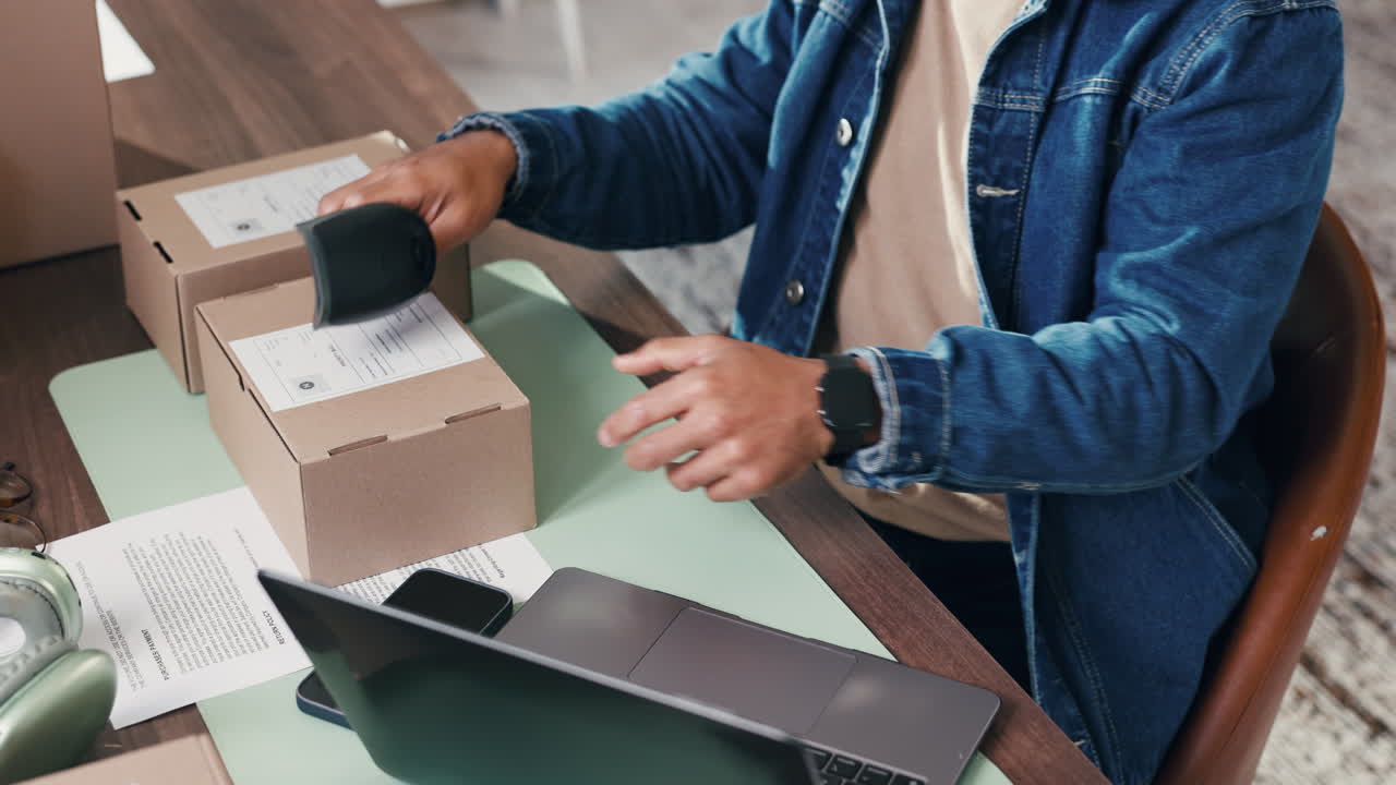 Man Scanning Package and Typing on Laptop for E-commerce Business