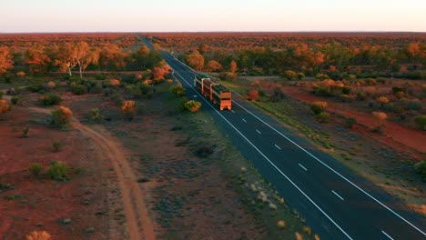 aerial view of a road train passing by on stuart highway - northern territory, australia