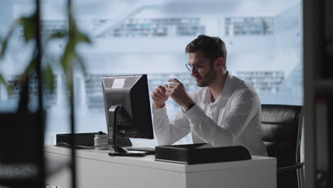 exhausted man taking off glasses feeling eye strain from computer. stressed overworked businessman taking off glasses tired from computer.